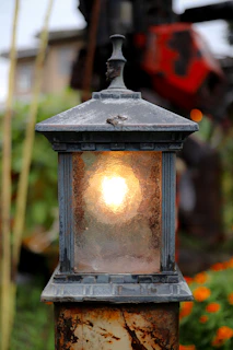 Vetrinaluce outdoor lanterns glowing softly along a garden path at dusk.
