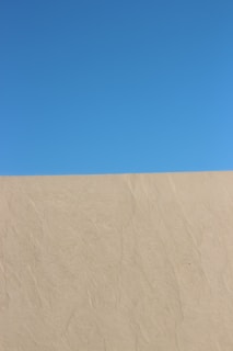 a man riding a snowboard down the side of a snow covered slope