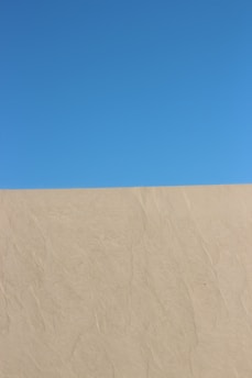 a man riding a snowboard down the side of a snow covered slope