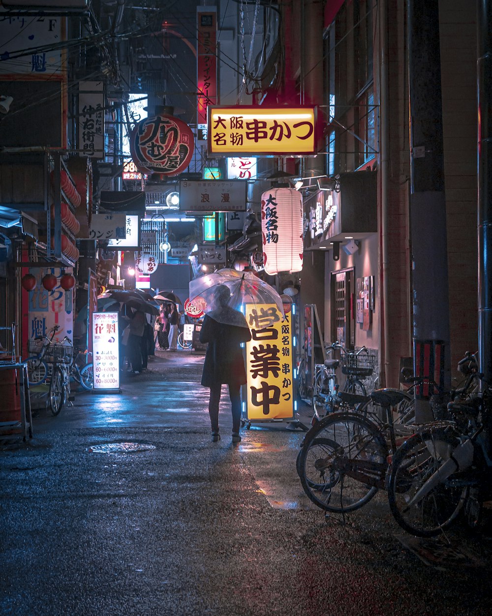 a person walking down a street holding an umbrella