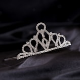 a tiara on a black cloth with a black background