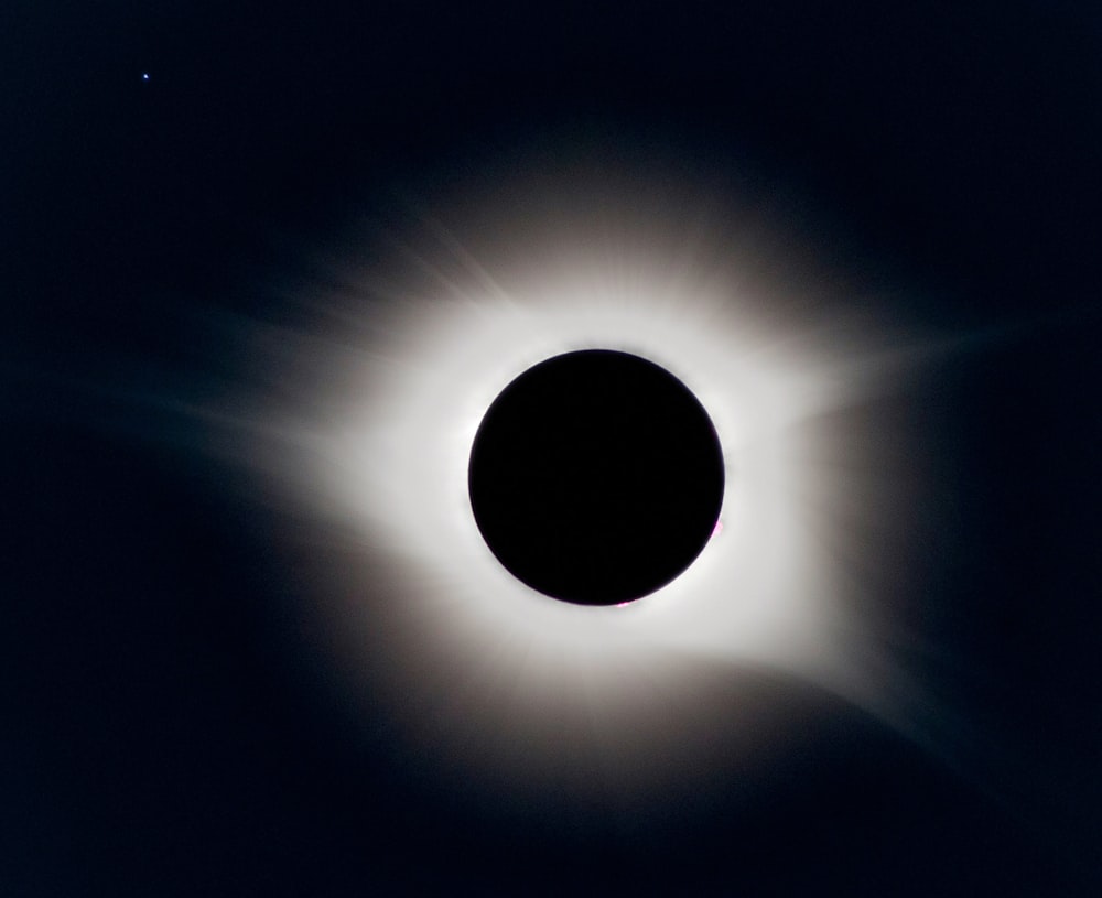 a solar eclipse is seen in the dark sky