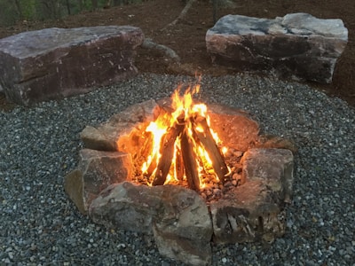 A custom-built fire pit surrounded by natural stone seating.
