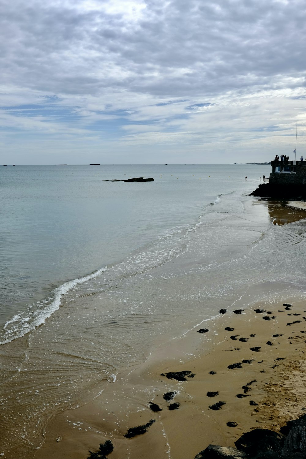 a sandy beach with a boat in the distance