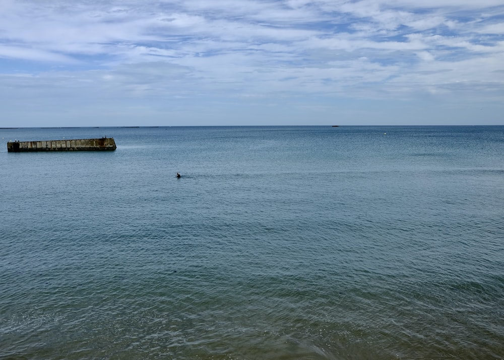 a body of water with a boat in the distance