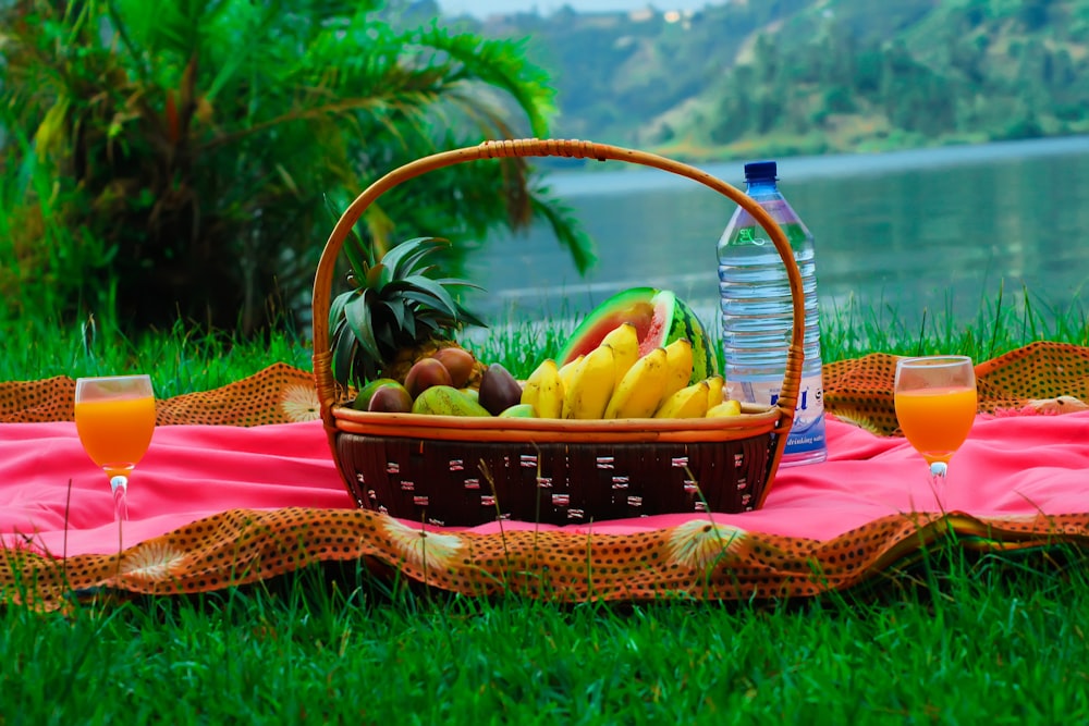 a basket of fruit sitting on top of a blanket