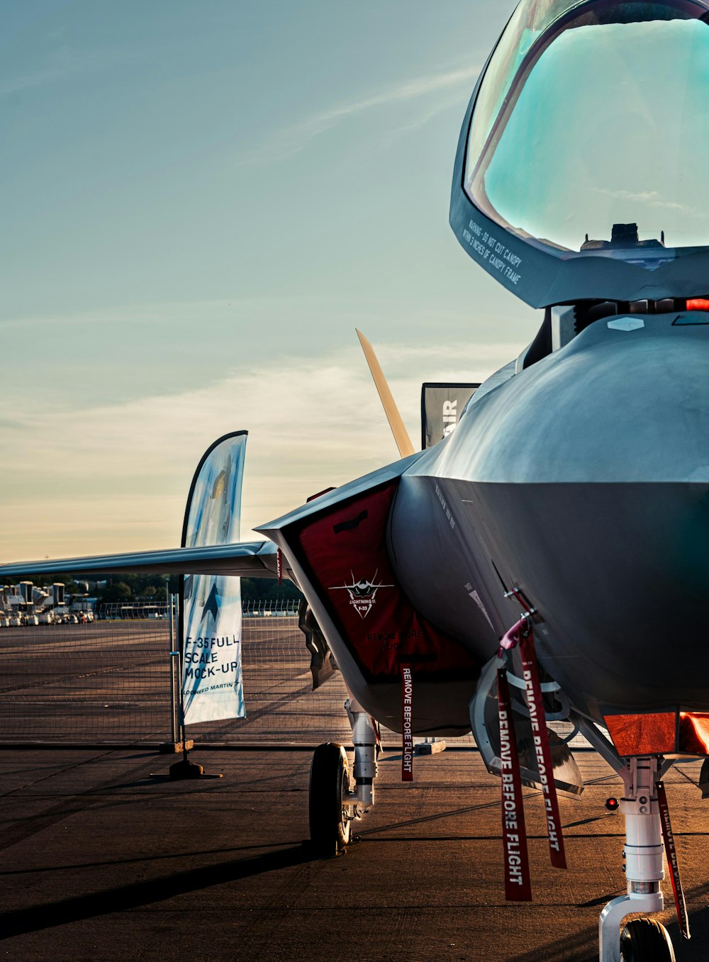 a fighter jet sitting on top of an airport tarmac