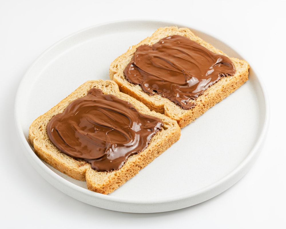 two pieces of bread with chocolate spread on them