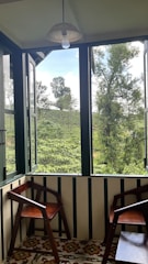 Cozy balcony view of the duplex apartment with sunlight filtering through the glass doors
