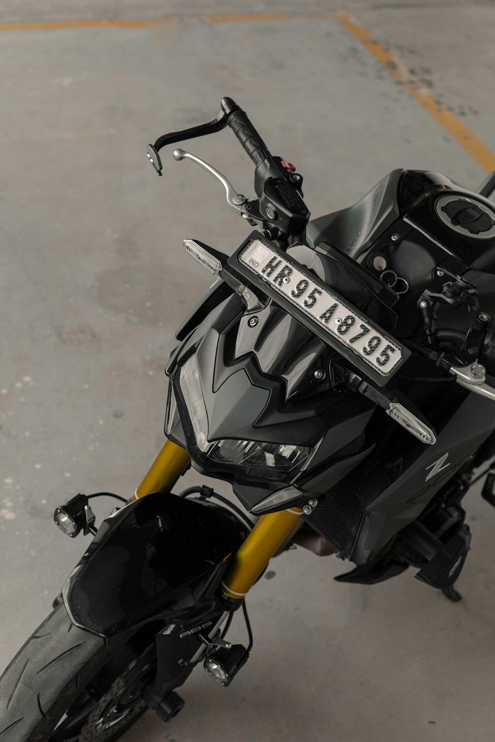 a black and yellow motorcycle parked in a parking lot