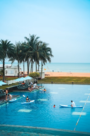 A lively swimming pool scene with swimmers and coaches engaged in training.