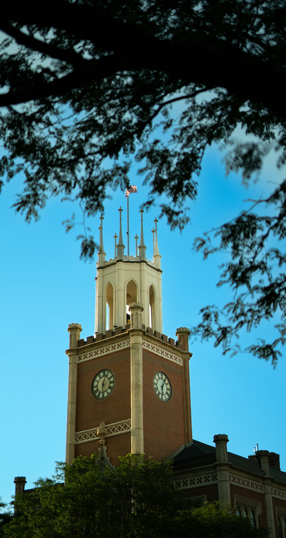 a tall clock tower with a clock on each of it's sides