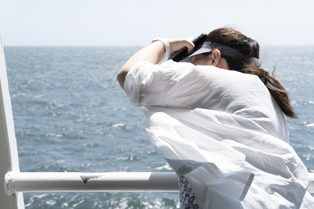 a woman looking out over the ocean from a boat