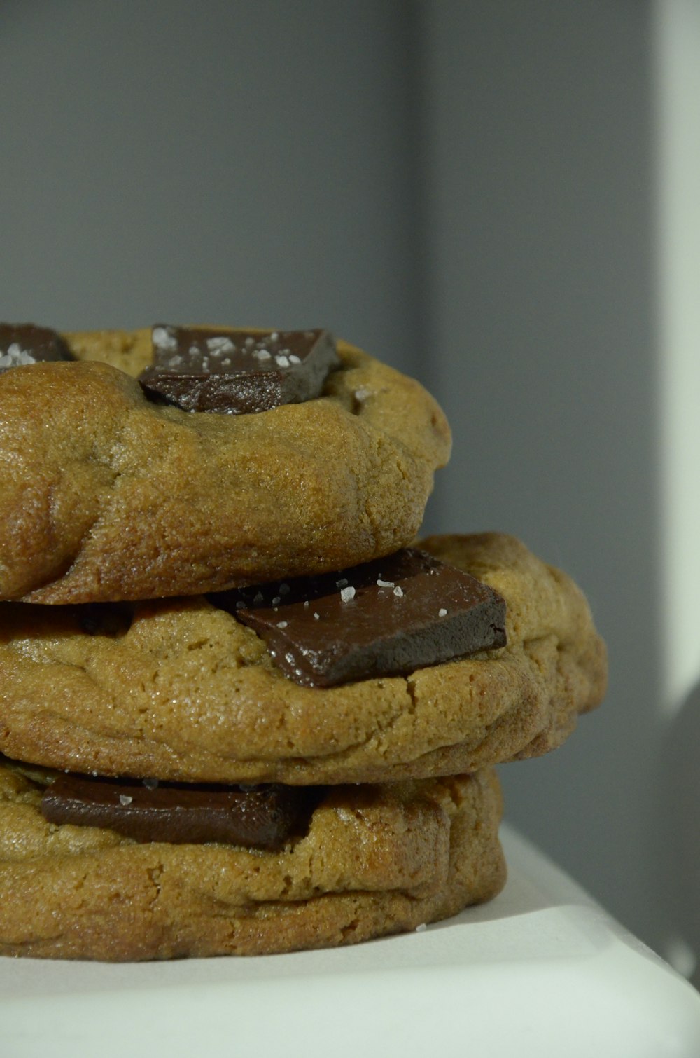 a stack of chocolate chip cookies sitting on top of each other