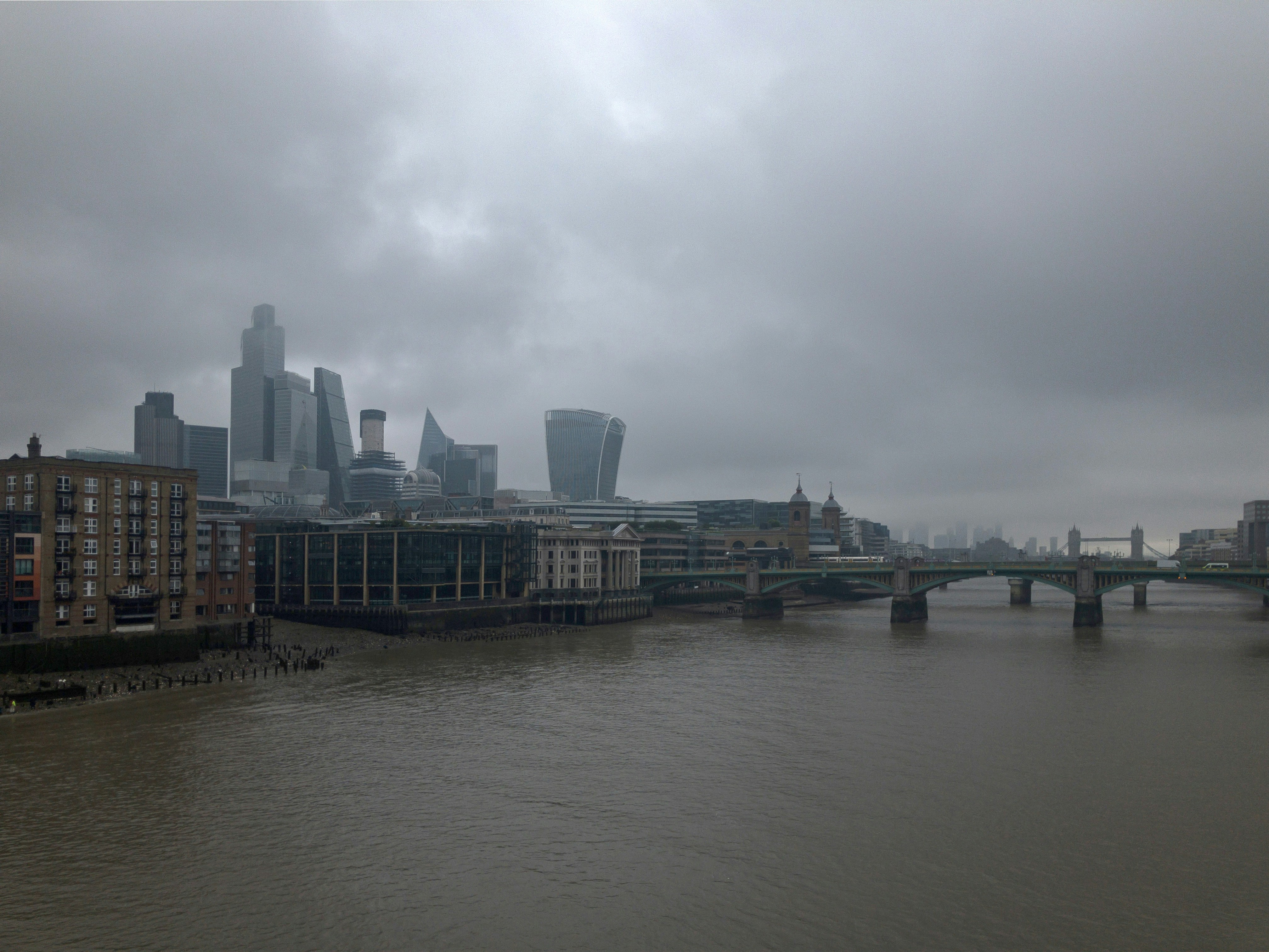 a river with a bridge and a city in the background
