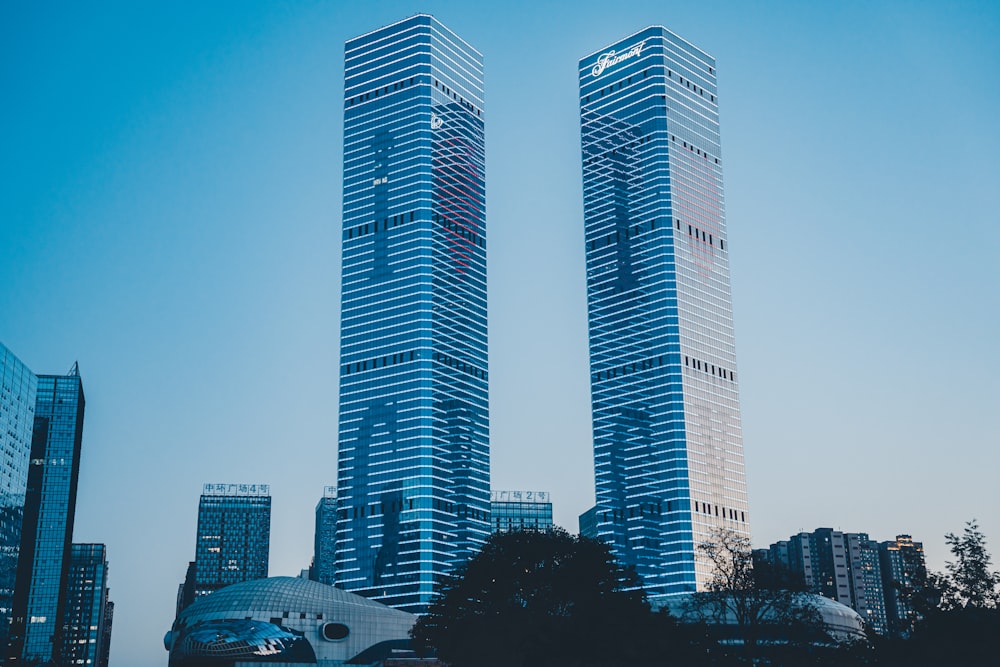 a couple of tall buildings sitting next to each other