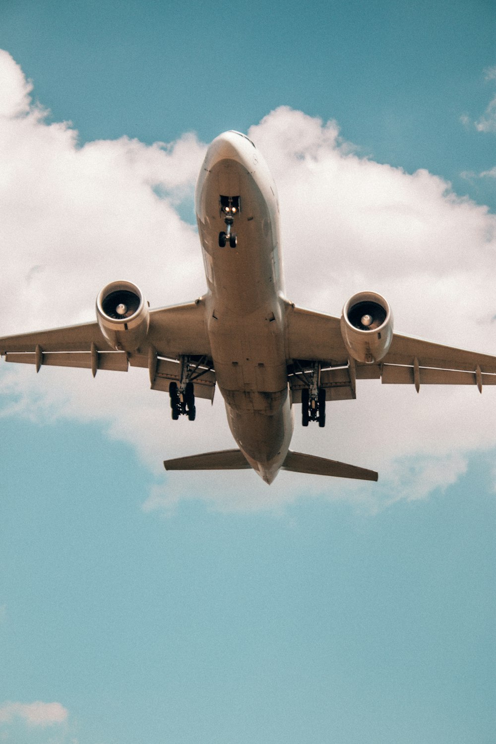 a large jetliner flying through a cloudy blue sky