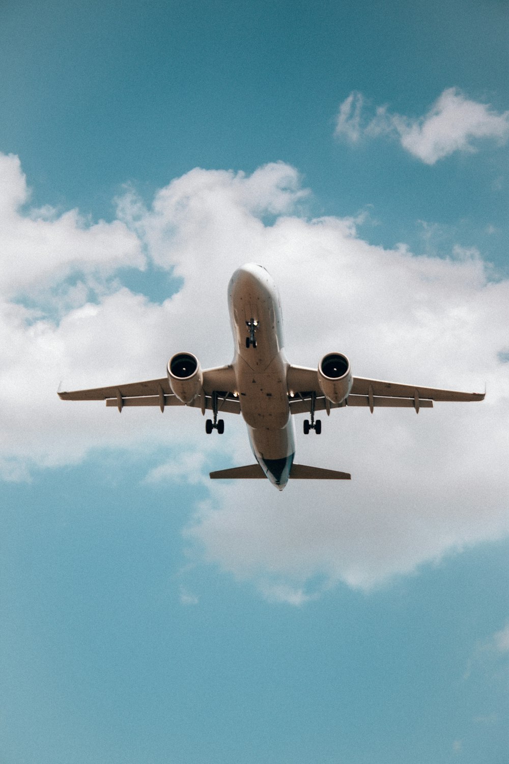 a large jetliner flying through a cloudy blue sky