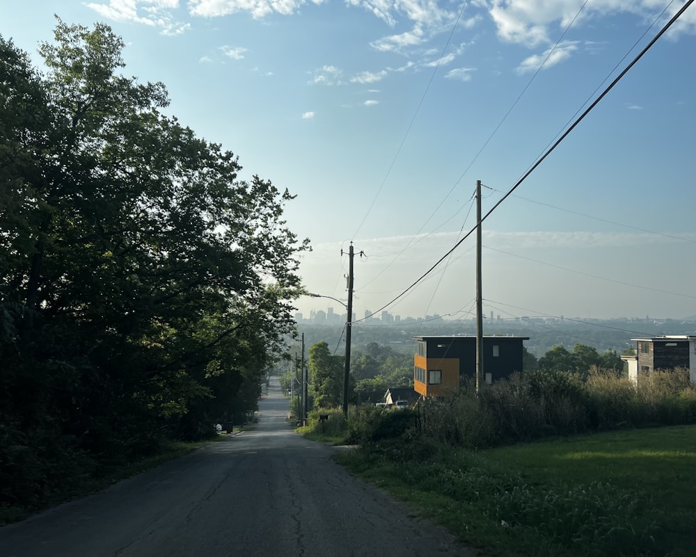 a dirt road with power lines and telephone poles