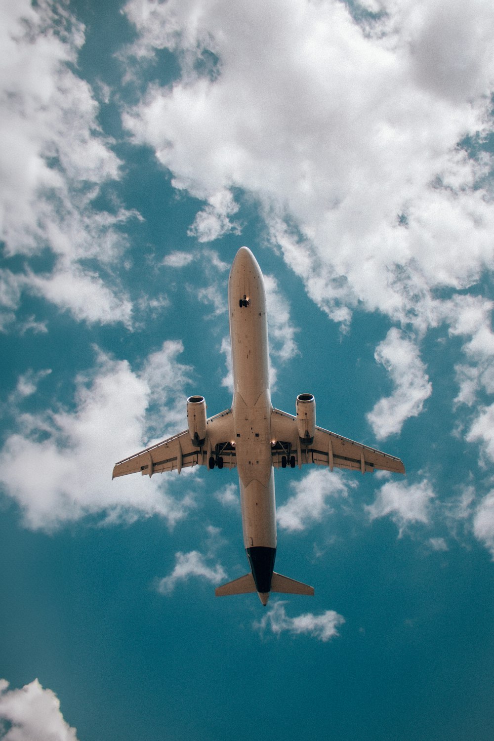 a large jetliner flying through a cloudy blue sky