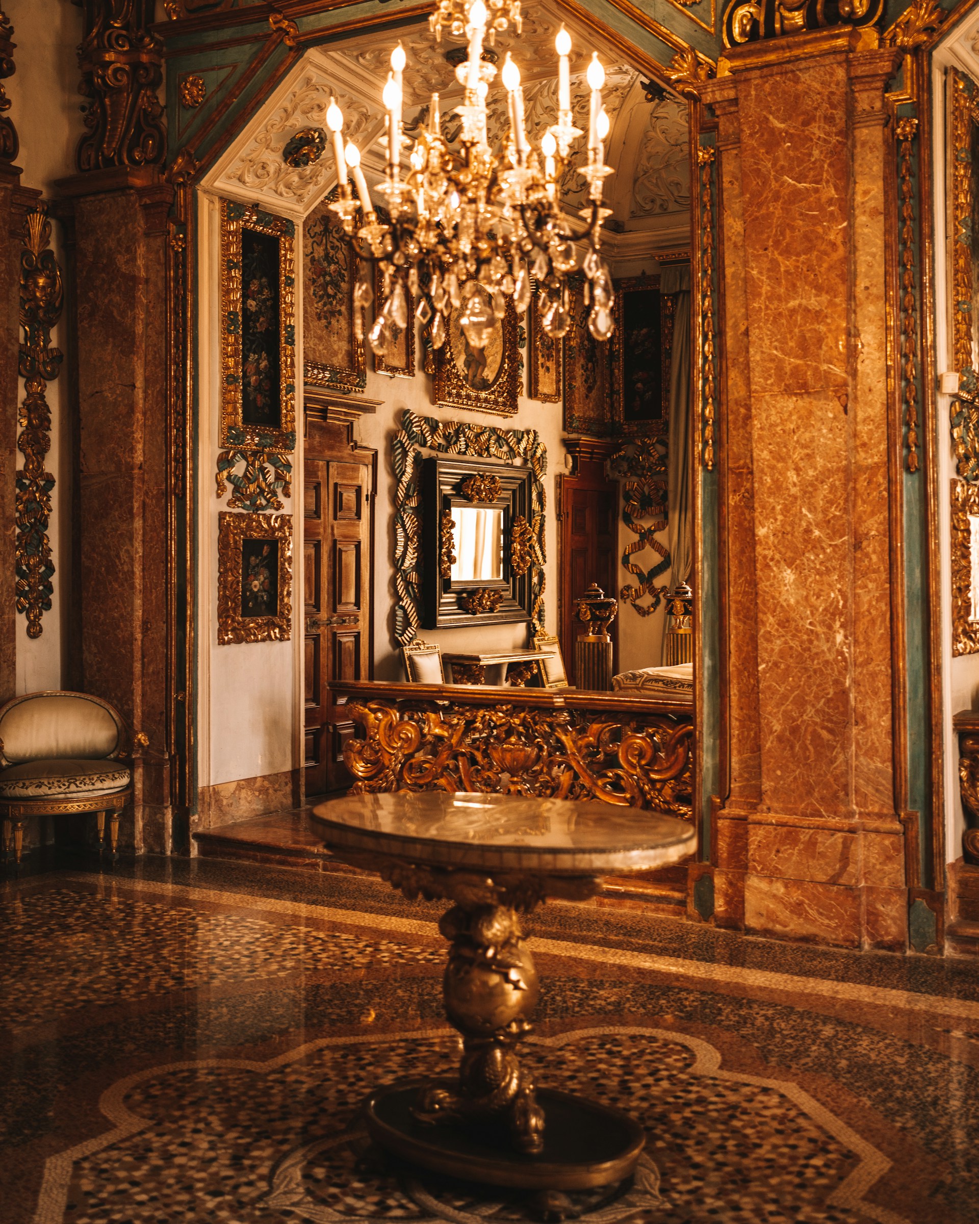 a fancy room with a chandelier and a mirror