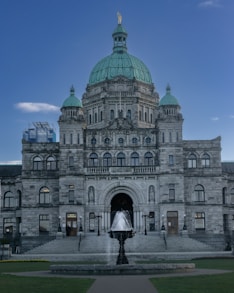 a large building with a fountain in front of it