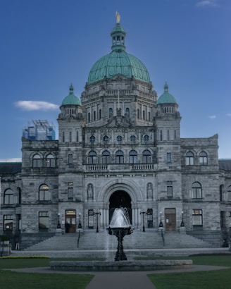a large building with a fountain in front of it