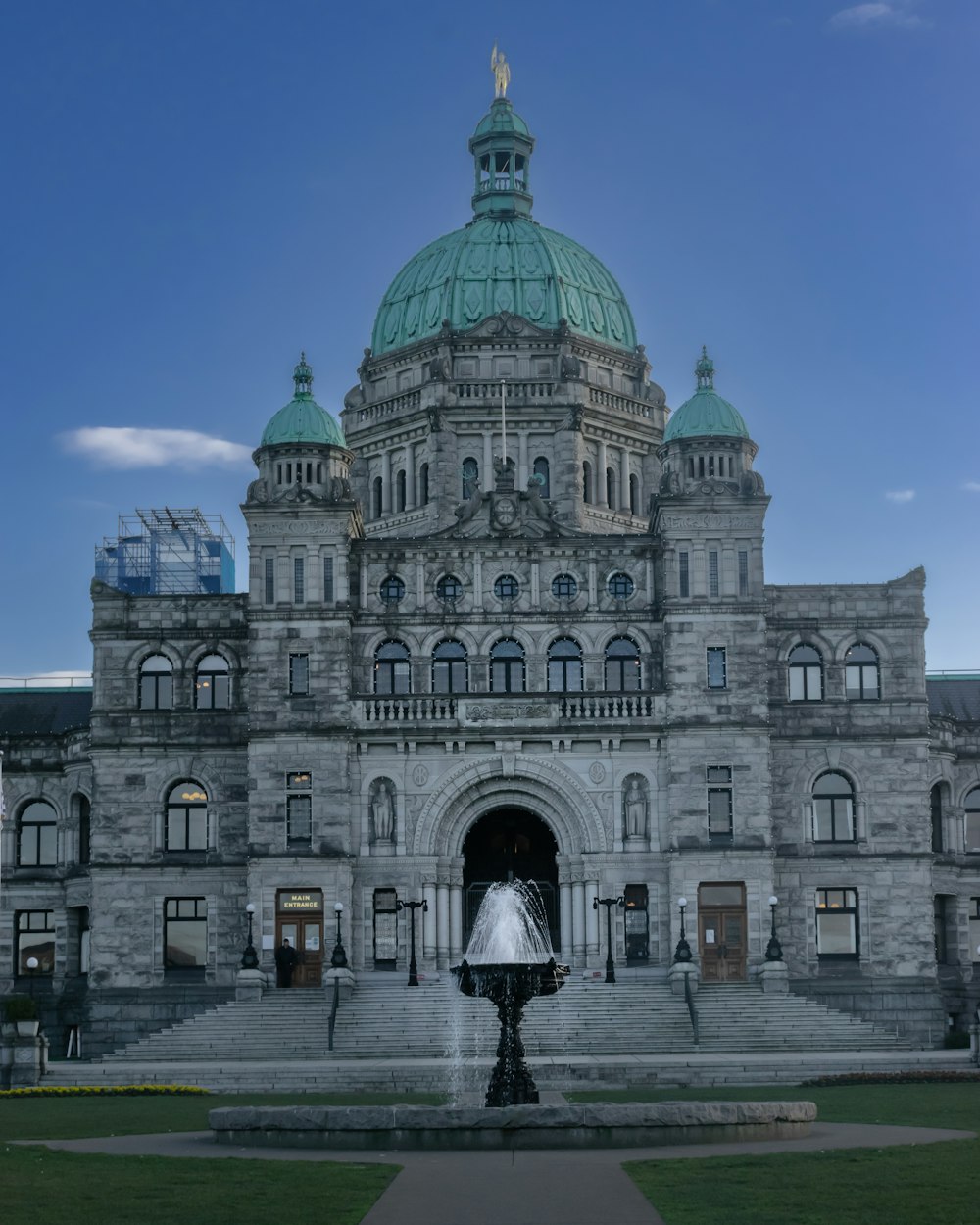 a large building with a fountain in front of it