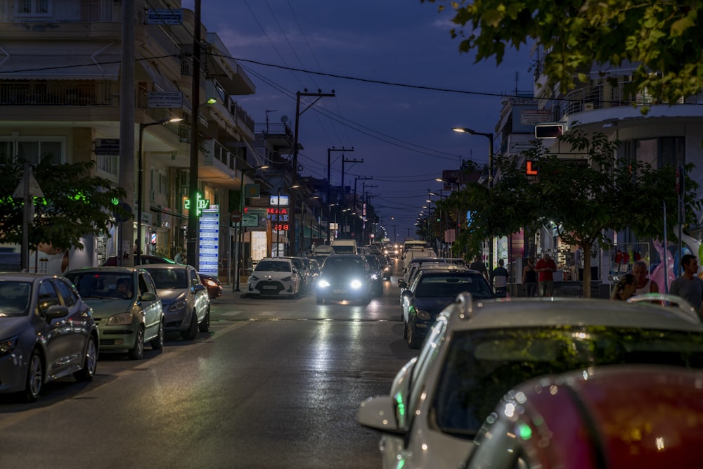 a city street filled with lots of traffic at night