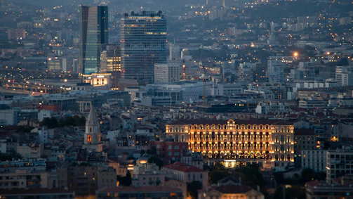 Cityscape showcasing government buildings illuminated at dusk, reflecting strategic partnerships.