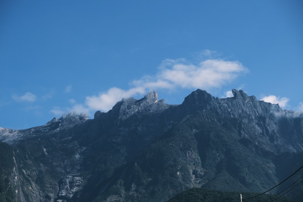 a view of a mountain range with clouds in the sky