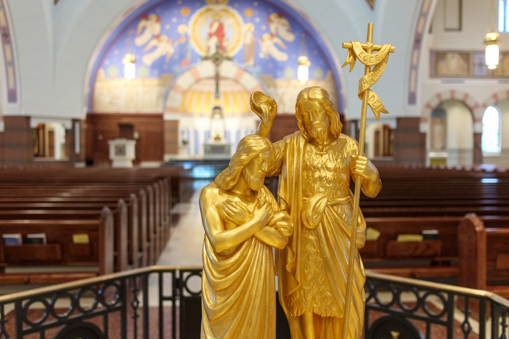 a statue of a woman holding a cross in a church