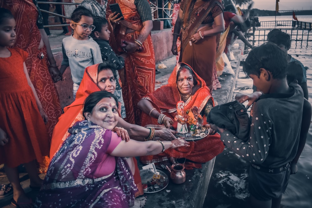 a group of people standing around each other