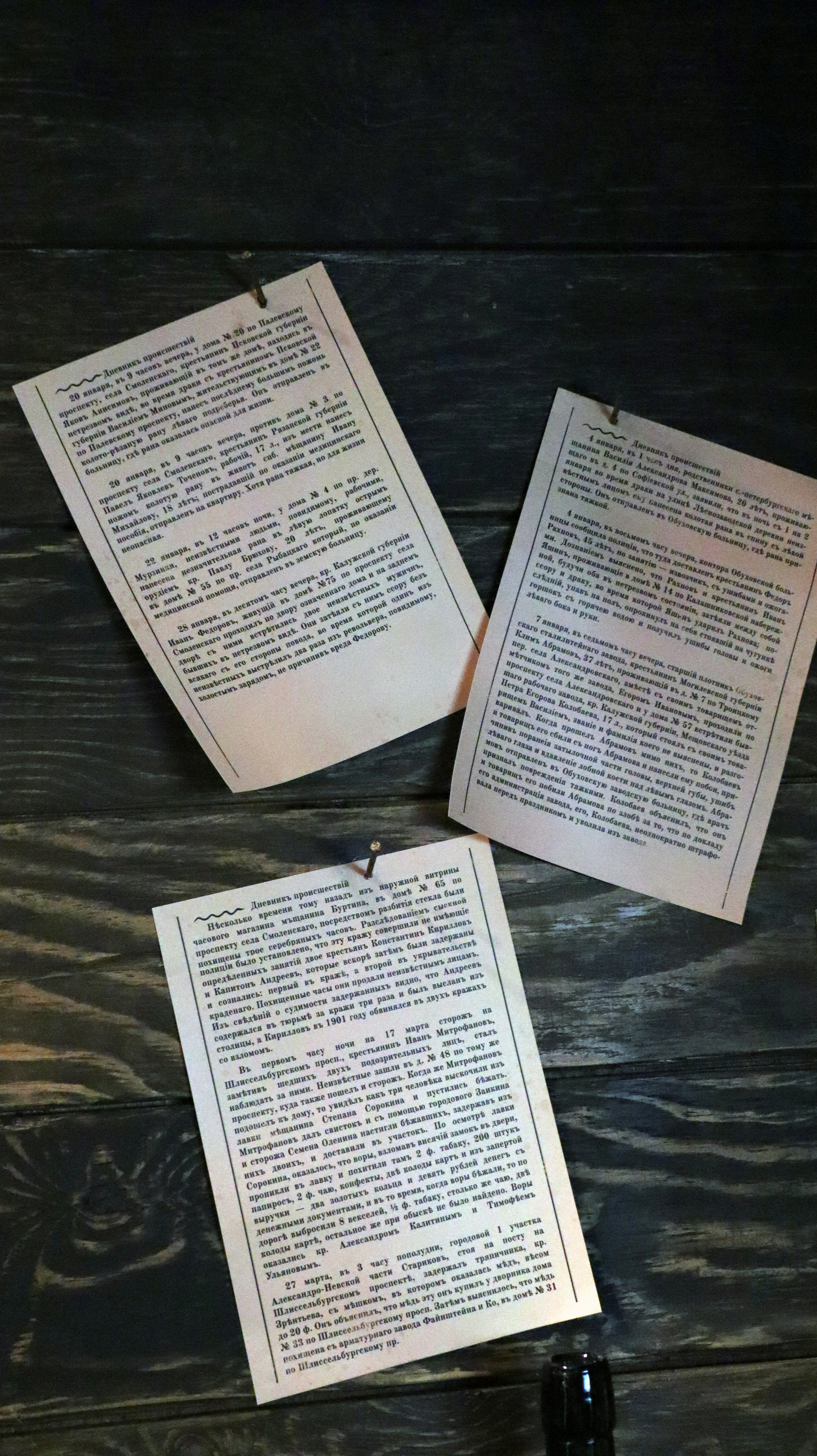 three pieces of paper on top of a wooden table