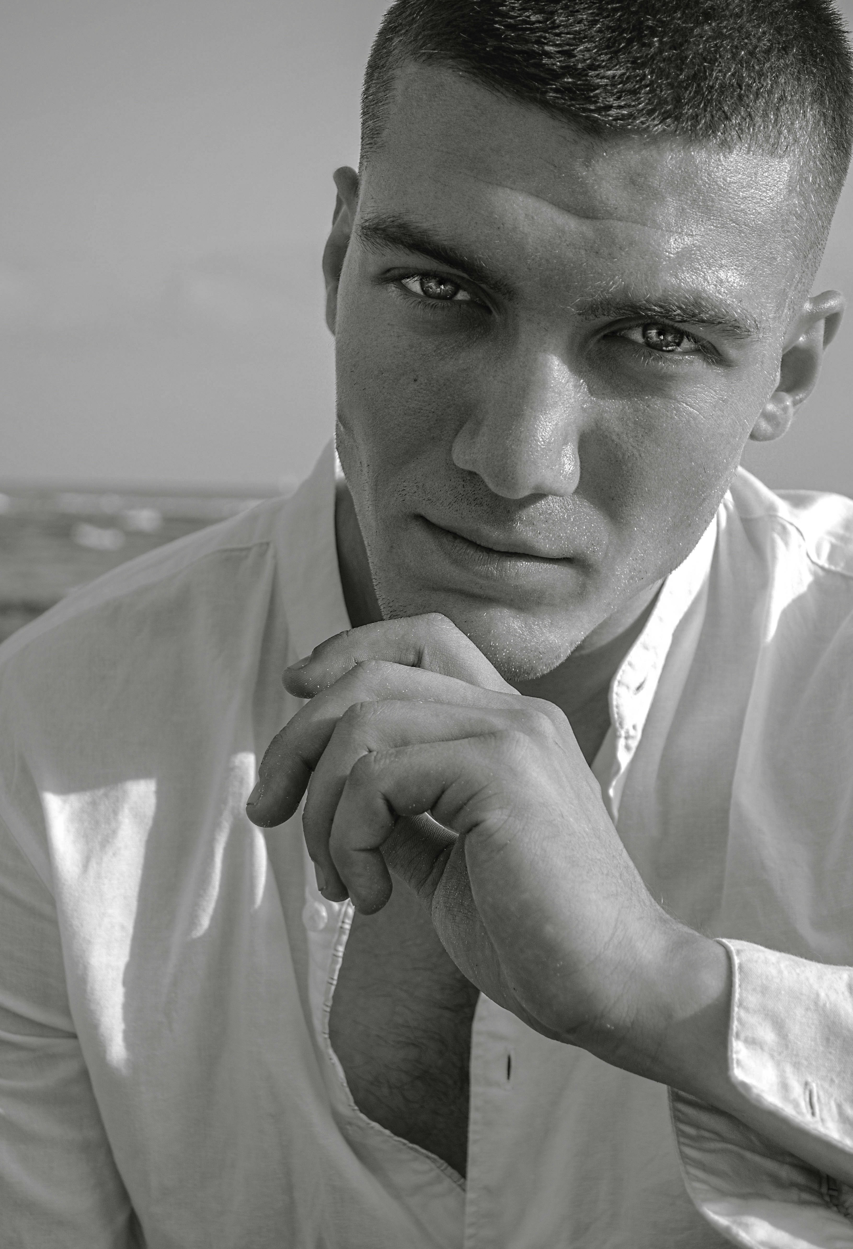 a black and white photo of a man in a shirt and tie