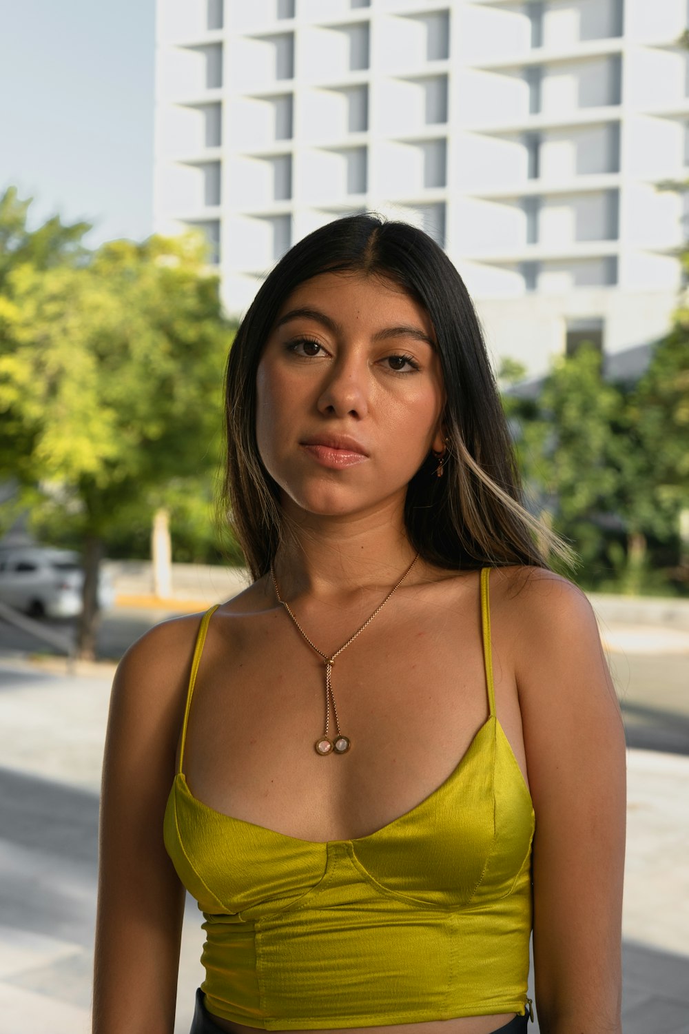a woman in a yellow top posing for a picture