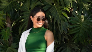 a woman wearing sunglasses and a green dress