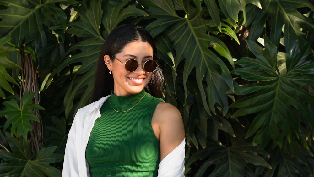 a woman wearing sunglasses and a green dress