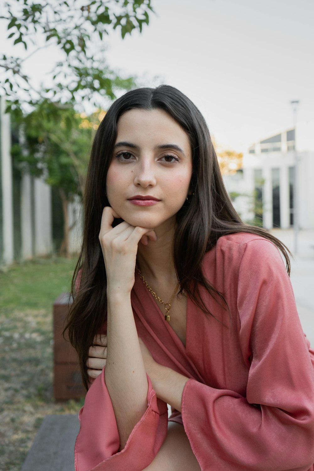 a woman in a pink shirt posing for a picture