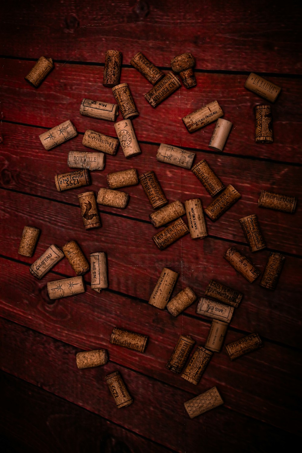 a bunch of wine corks on a wooden table