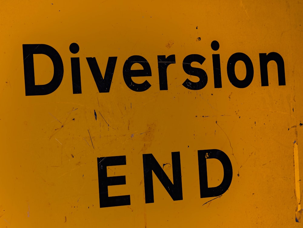 a close up of a street sign with the words diversion end