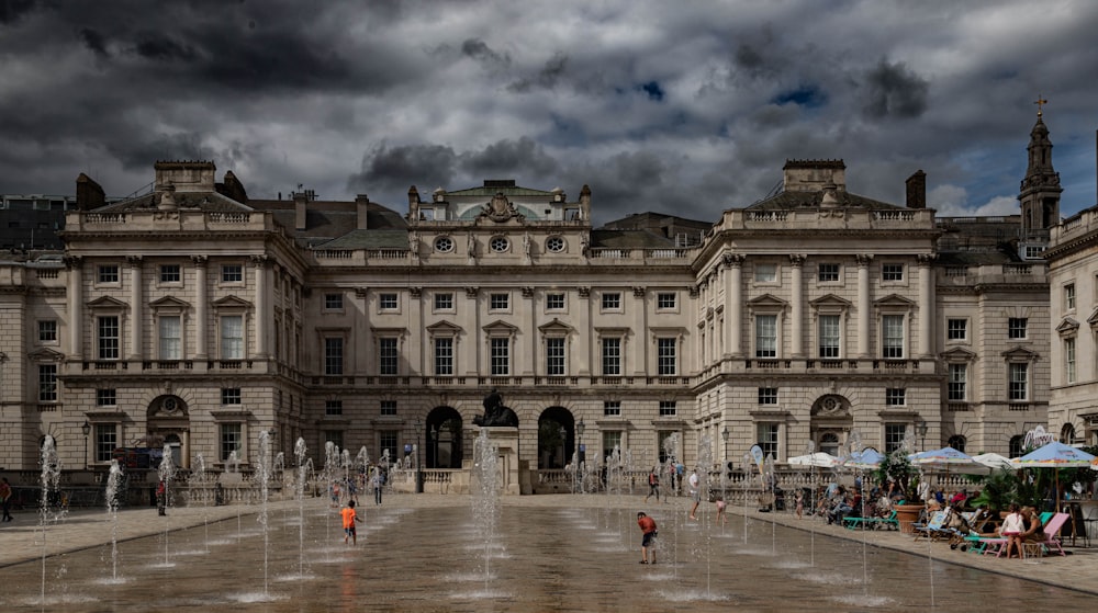 a large building with a fountain in front of it