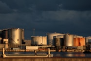 a large industrial area with a body of water in front of it