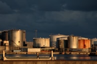 a large industrial area with a body of water in front of it