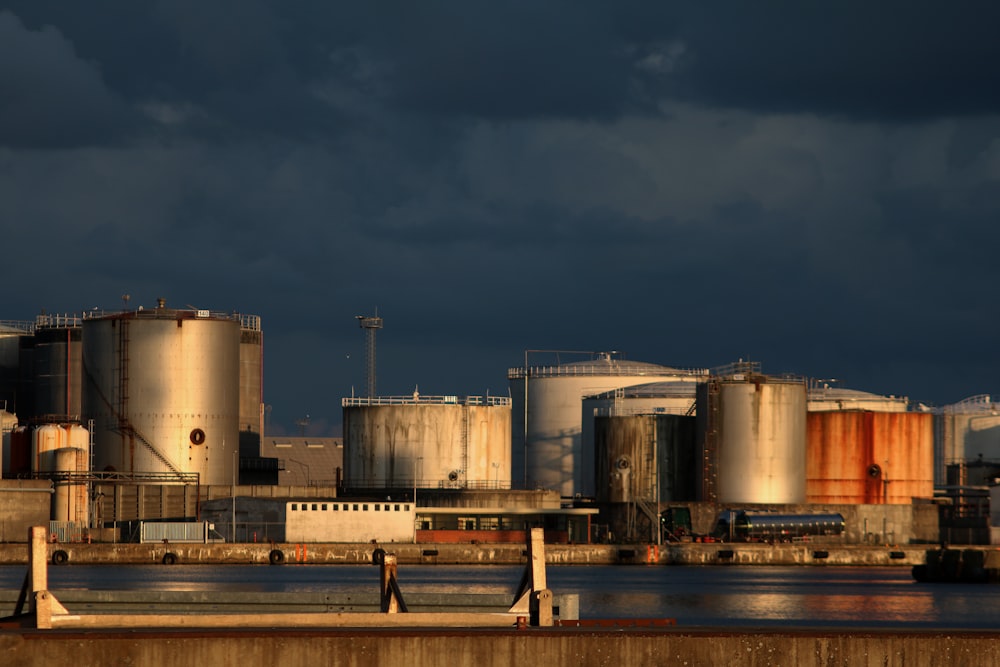 a large industrial area with a body of water in front of it