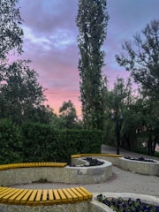 A calm outdoor meditation circle in a park at sunset.
