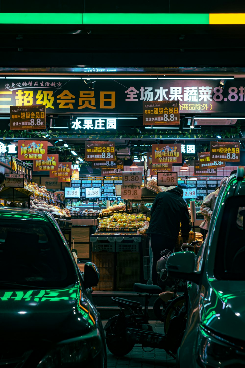 a man is standing in front of a fruit stand