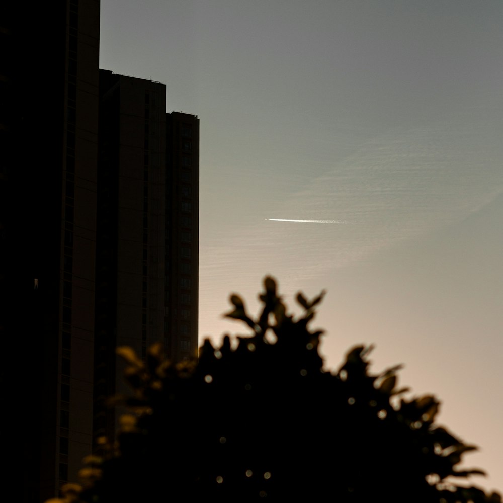 a plane flying in the sky over a city