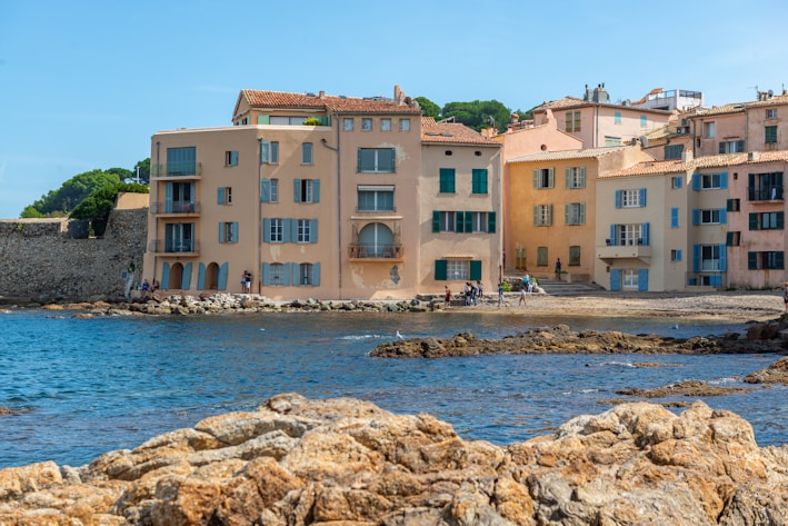 a group of buildings next to a body of water