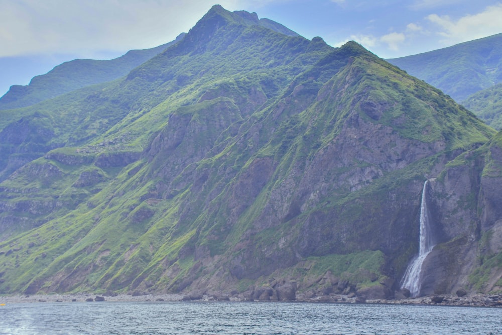 a large waterfall in the middle of a body of water